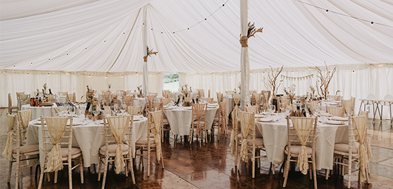 Marquee reception at Gradbach Mill with round tables dressed in cream linen.