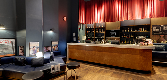 Lounge with blue banquette seating and vintage wartime posters