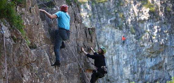Rock climbers scaling a cliff face at Cheddar Gorge