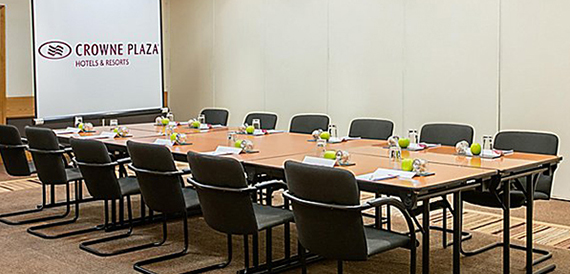 U-shaped meeting room with tables set for a small conference
