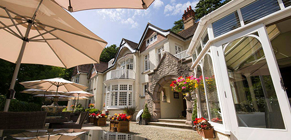 Chateau La Chaire's turreted exterior with colourful hanging flowers and a striped awning