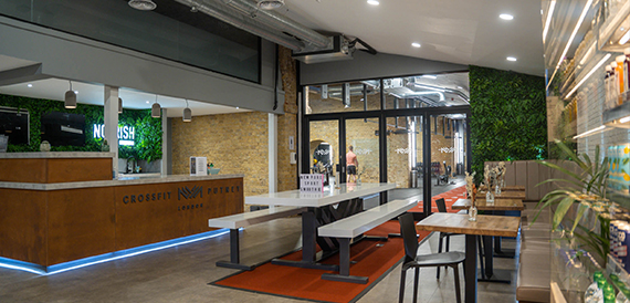 Cafe counter and communal bench seating near the entrance doors