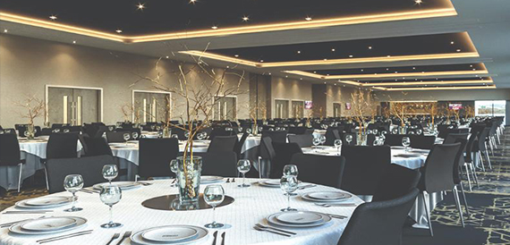 Dining room with round tables and dramatic branch centrepieces