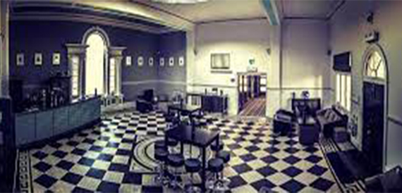 Room with a black and white chequered floor and arched window