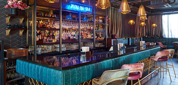 Highline Bar counter in teal tiling with pink and green velvet stools