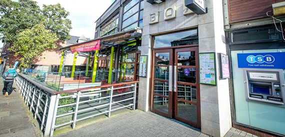 Box Headingley's exterior with bright yellow pillars and glass frontage