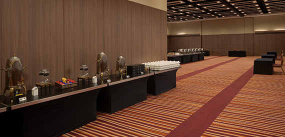Catering station with chafing dishes and cups beside the main ballroom