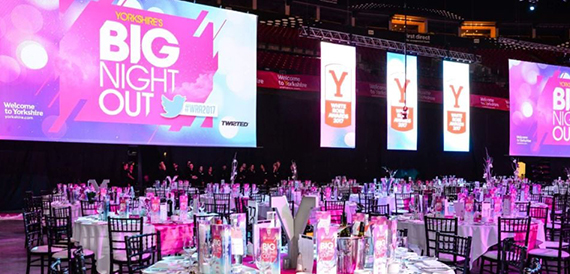 Arena banqueting tables set beneath pink screens reading 'Yorkshire's Big Night Out'.