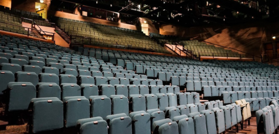 Close rows of teal auditorium seating
