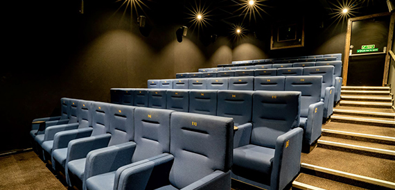 Screening room with blue seats and star-shaped ceiling lights