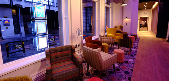 Lounge with striped armchairs and purple ambient lighting