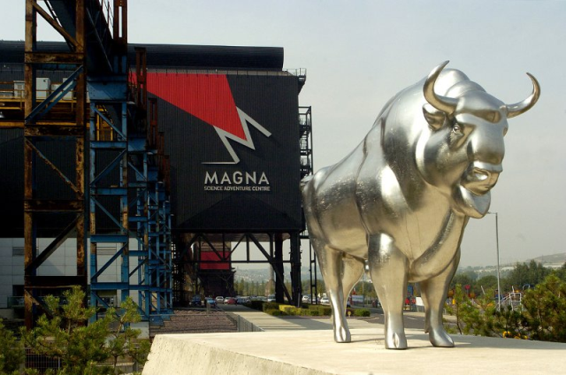Large steel bull sculpture standing outside the Magna Science Adventure Centre building