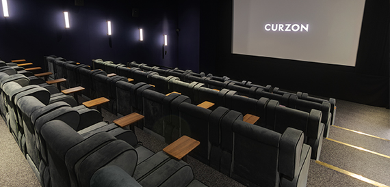 Cinema screening room with grey velvet seats and purple ambient lighting