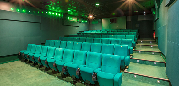 Cinema auditorium with green seats and green accent lighting