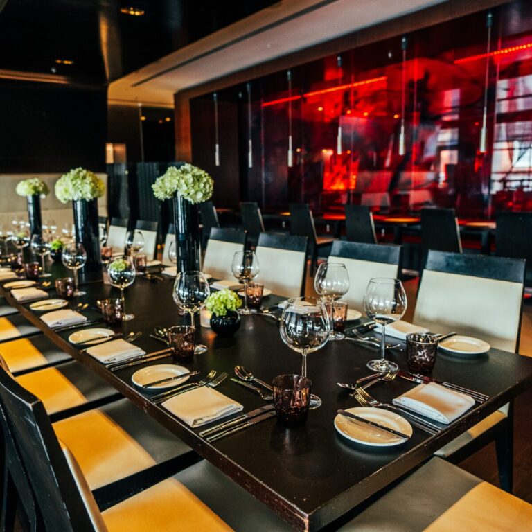 Brasserie Joel private dining table set with white flowers and red lighting