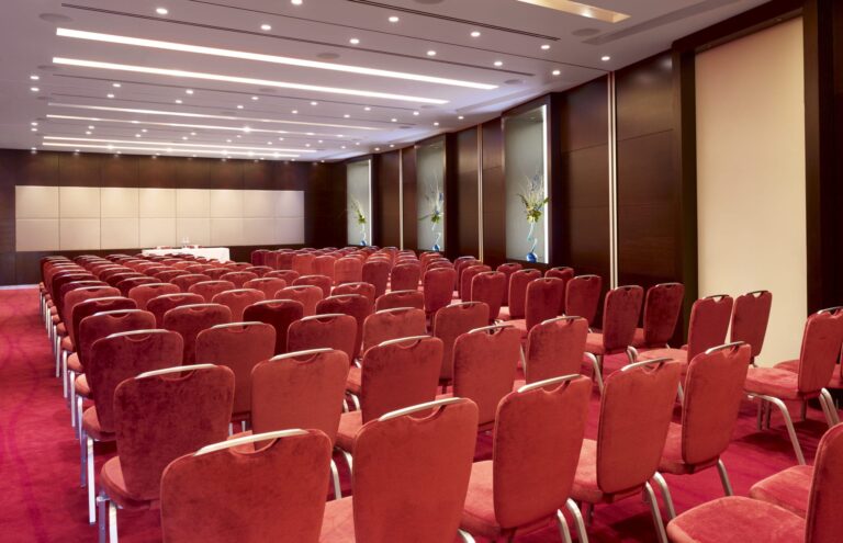 Conference Suite set theatre-style with red chairs facing a presentation wall