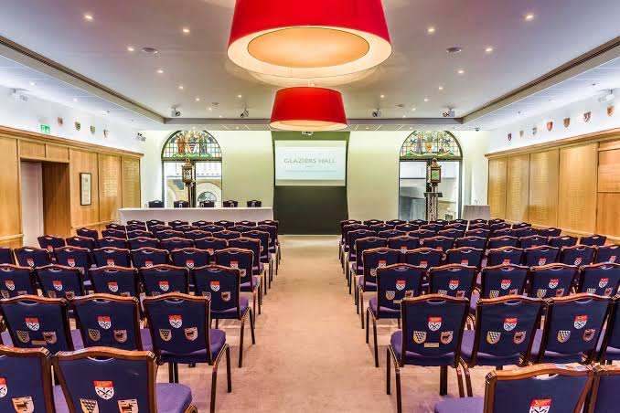 Court Room set theatre-style with navy chairs facing a stage