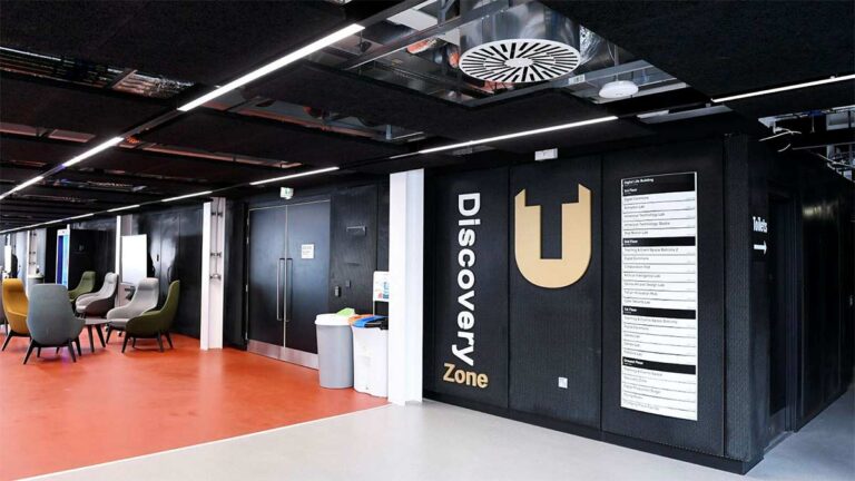 Discovery Zone entrance with orange flooring and lounge seating area