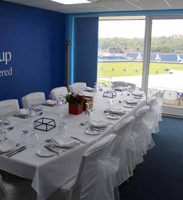 Executive box with a long table set formally and a pitch view