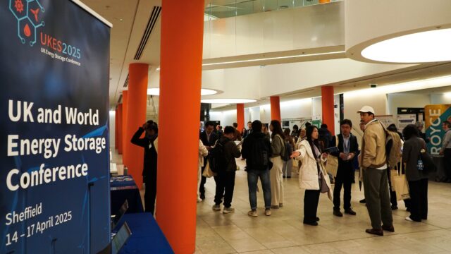 Exhibition hall lobby with delegates networking beside conference banner stands