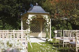 Garden gazebo decorated with flowers for an outdoor wedding ceremony