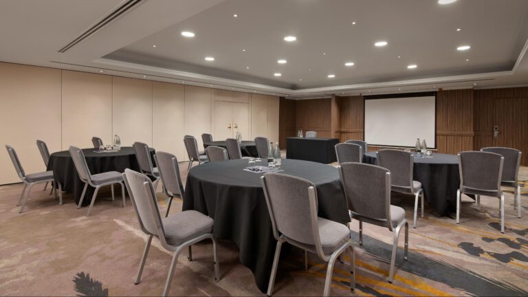 Gunnell Room set cabaret-style with round tables facing a screen
