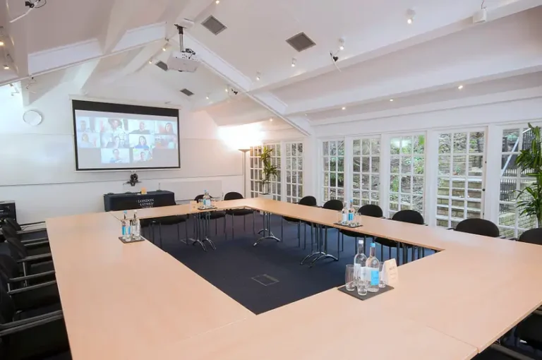 Hardy Room set U-shaped with a projector screen and French windows