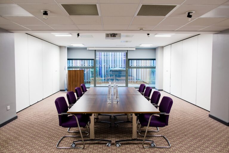 Small meeting room with a boardroom table and skyline view