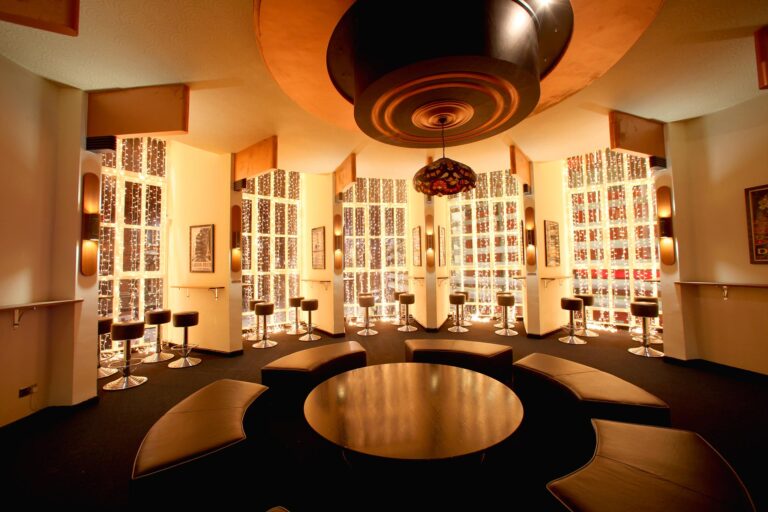Circular VIP lounge with a round table and illuminated wall panels