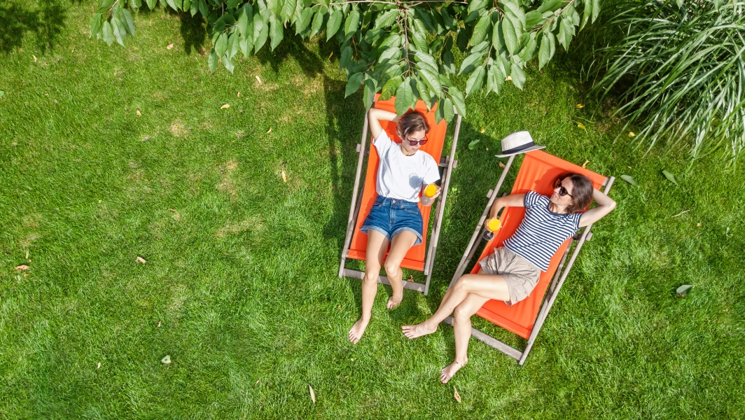 Two people relaxing in deckchairs on the lawn, viewed from above