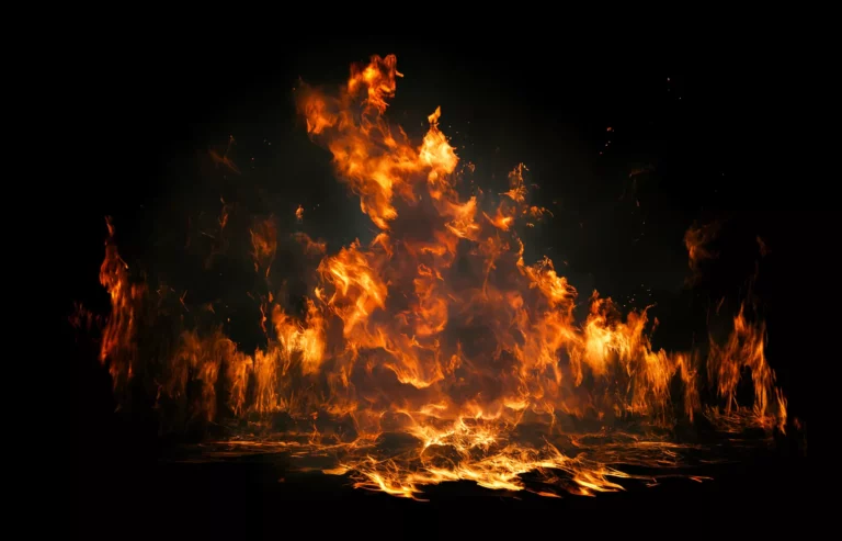 Close-up of orange flames burning against a dark background