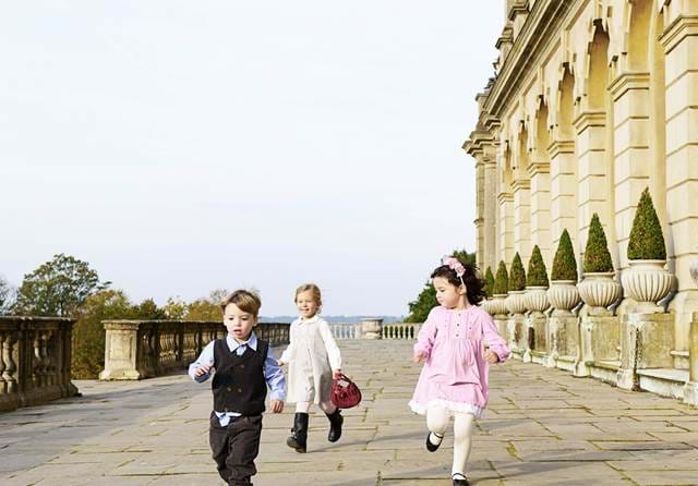 Children walking along Cliveden's stone terrace outside the house